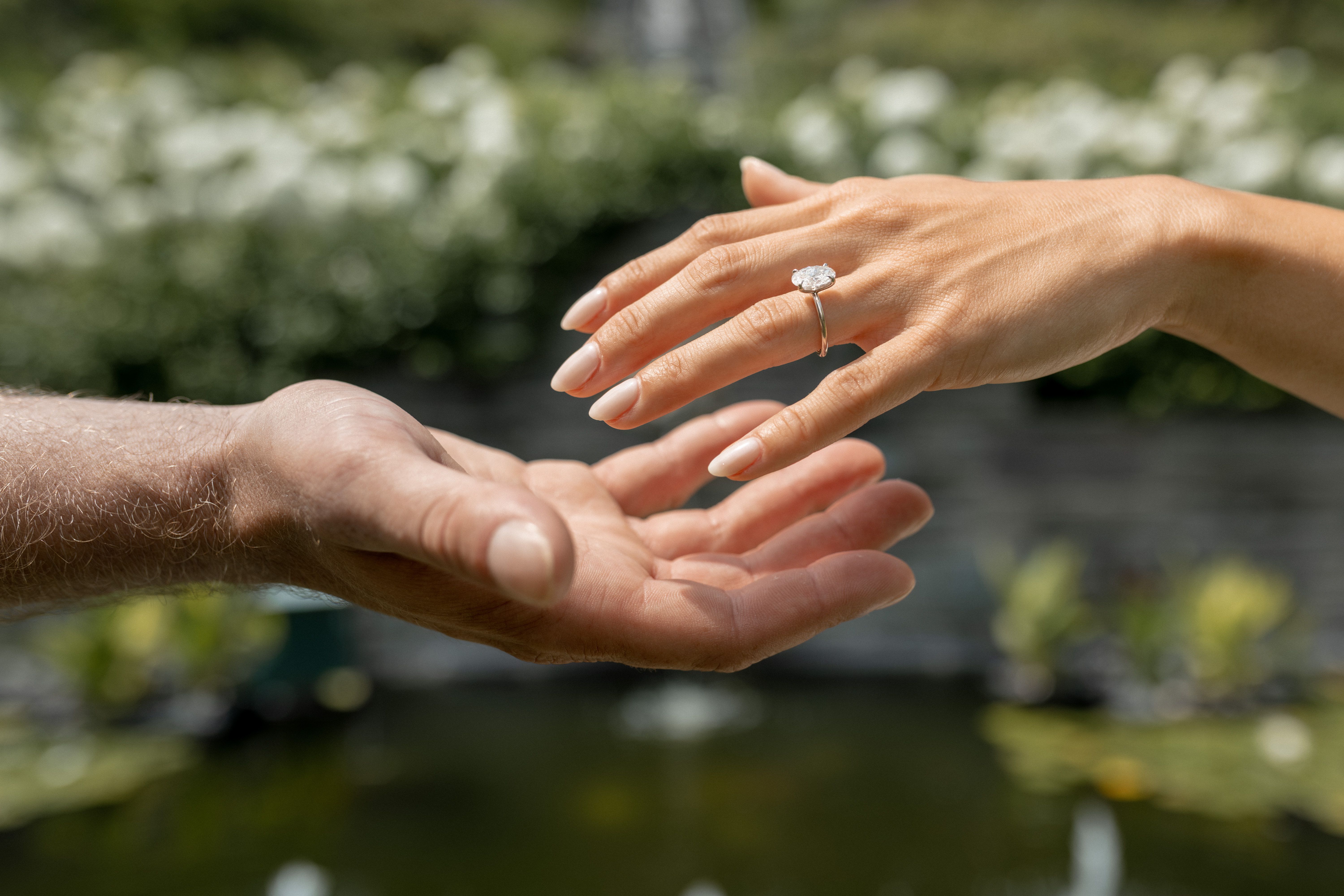 Romantic engagement ring detail - couple holding hands with diamond ring by Bailey Bryn Photography Milwaukee