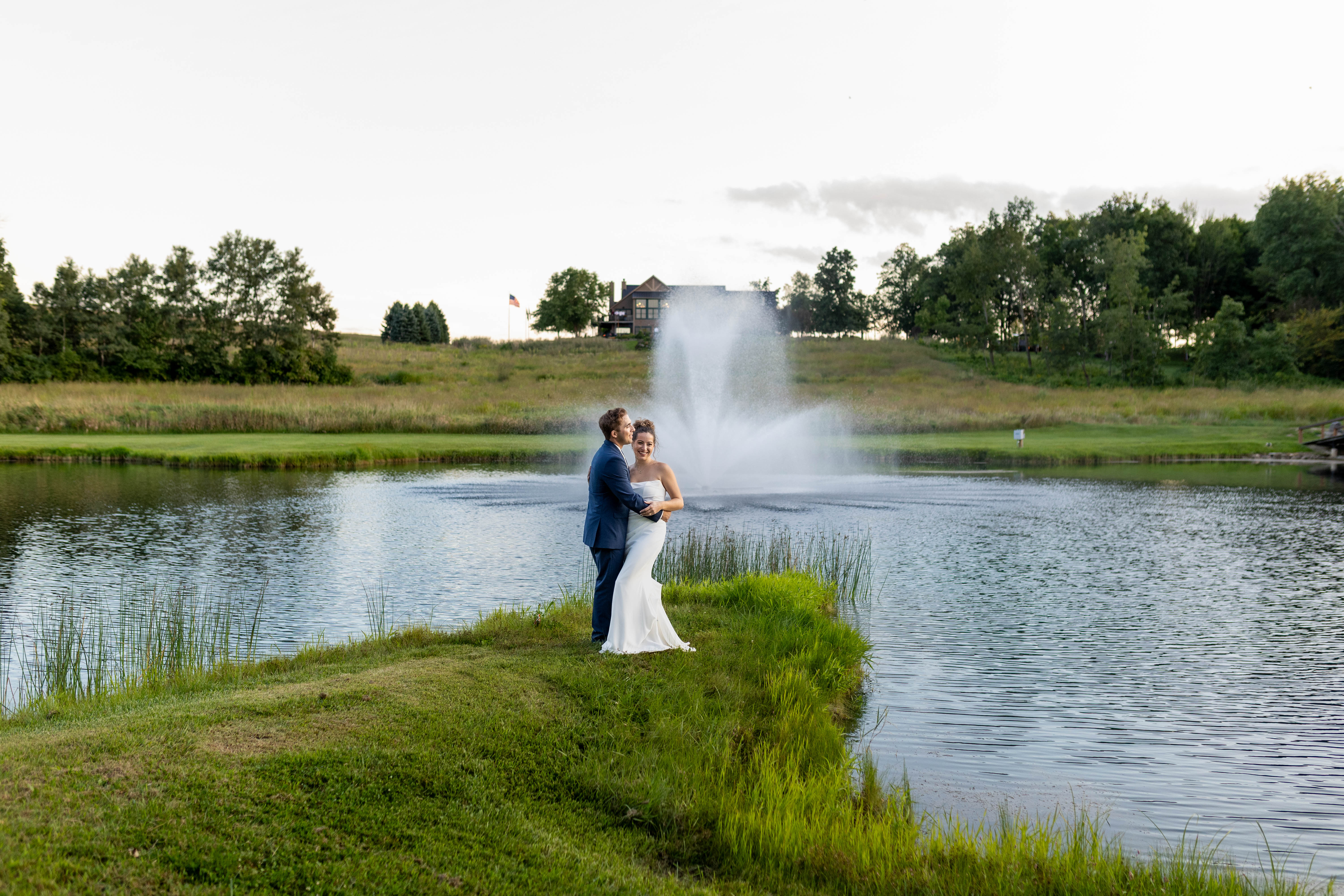 Romantic couple portrait by pond with fountain