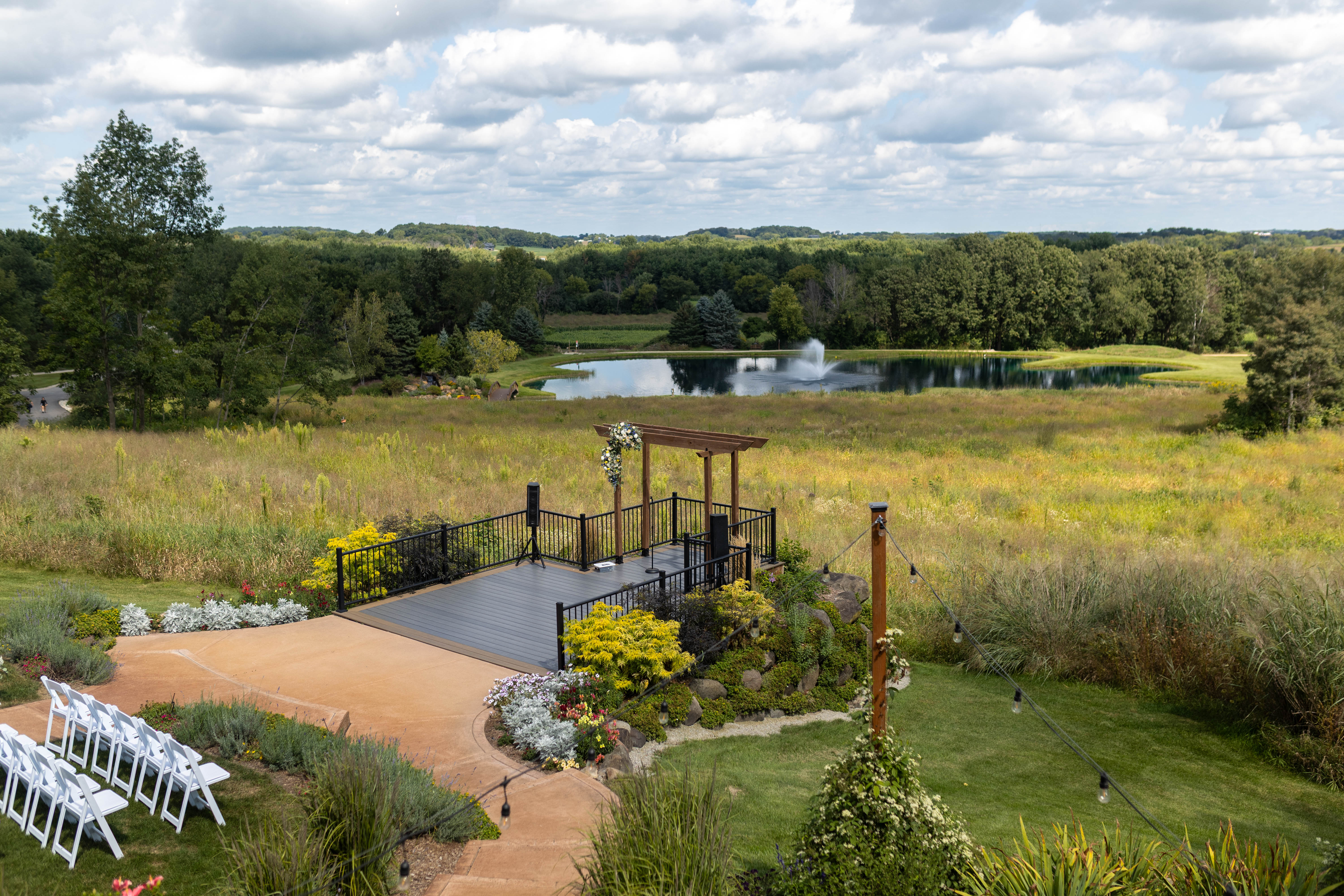 Wisconsin wedding venue ceremony site with pergola overlooking pond
